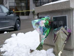 Flowers are left outside a condominium building the day after a shooting in Vaughan, Ont., on Monday Dec, 19, 2022. A former resident and condo board member of a building north of Toronto where a gunman killed five people in a rampage recounts how much the community tried to help the man before it was too late.