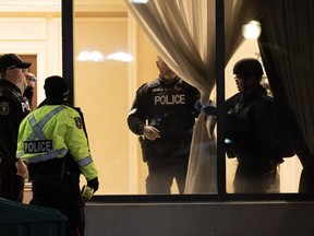 Police are seen in the lobby of a condo building following a shooting in Vaughan, Ont., Sunday, Dec. 18, 2022. A 66-year-old woman who was shot in a rampage at a condominium north of Toronto is going to live, but has a long road to recovery.