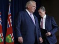 Ontario Premier Doug Ford and Toronto Mayor John Tory, shuffle during a joint press conference inside Queen's Park in Toronto, June 27, 2022.