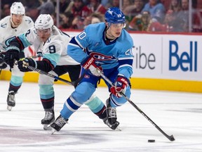 Montreal Canadiens' Juraj Slafkovsky skates sway from Seattle Kraken's Ryan Donato during third period in Montreal on Jan. 9, 2023.