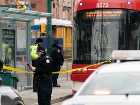 Police cars surround a TTC streetcar on Spadina Ave. after a woman, 23, was stabbed in a random attack on Tuesday, Jan. 24, 2023.