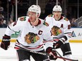 ELMONT, NEW YORK - DECEMBER 04: Jonathan Toews #19 and Patrick Kane #88 of the Chicago Blackhawks skates against the New York Islanders during the second period at the UBS Arena on December 04, 2022 in Elmont, New York.