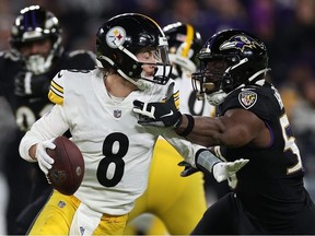 Kenny Pickett of the Pittsburgh Steelers breaks a tackle from Justin Houston of the Baltimore Ravens during the second quarter at M&T Bank Stadium on January 01, 2023 in Baltimore, Maryland.
