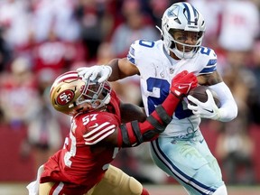 Tony Pollard of the Dallas Cowboys carries the ball against Dre Greenlaw of the San Francisco 49ers during the second quarter in the NFC Divisional Playoff game at Levi's Stadium on January 22, 2023 in Santa Clara, California.