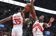 Charlotte Hornets' Dennis Smith Jr. (centre) has his shot attempt blocked by Raptors' Christian Koloko (left) and O.G. Anunoby during the first half at Scotiabank Arena on Tuesday, Jan. 10, 2023.