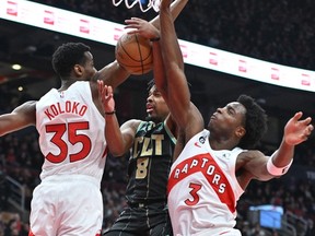 Charlotte Hornets' Dennis Smith Jr. (centre) has his shot attempt blocked by Raptors' Christian Koloko (left) and O.G. Anunoby during the first half at Scotiabank Arena on Tuesday, Jan. 10, 2023.