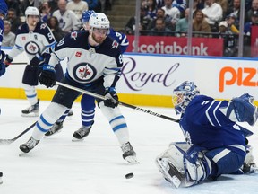Maple Leafs goaltender Ilya Samsonov makes a save as Winnipeg Jets' Pierre-Luc Dubois looks for a rebound during the third in Toronto on Thursday Jan. 19, 2023.