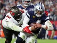 Dallas Cowboys quarterback Dak Prescott rushes the ball for a touchdown against the Tampa Bay Buccaneers defensive end Akiem Hicks in the first half during the wild card game at Raymond James Stadium.