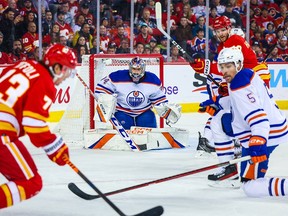 Edmonton Oilers goaltender Stuart Skinner (74) guards his net against the Calgary Flames during the second period at the Scotiabank Saddledome on Dec. 27, 2022.