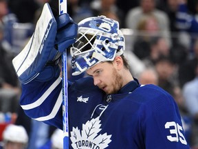 Toronto Maple Leafs goalie Ilya Samsonov adjusts his mask before play resumes against the St. Louis Blues in the second period at Scotiabank Arena.