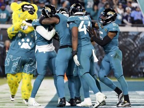 The Jaguars defence celebrates a touchdown by Josh Allen (left) during the fourth quarter against the Titans at TIAA Bank Field in Jacksonville, Fla., Saturday, Jan. 7, 2023.