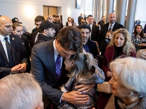 Prime Minister Justin Trudeau hugs Tourane Shamsolahi, the relative of victims, at an event marking the the third anniversary of the downing of Ukraine International Airlines flight PS752, which was shot down near Tehran by Iran's Revolutionary Guards, in Toronto, Sunday, Jan. 8, 2023.