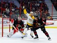 Ottawa Senators defenceman Travis Hamonic (23) checks Nashville Predators right wing Nino Niederreiter (22) in front of goaltender Cam Talbot during the second period on Monday night at the Canadian Tire Centre.