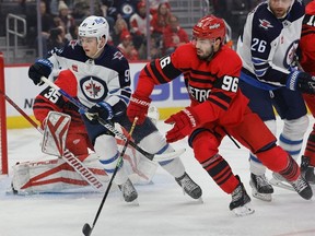 Winnipeg Jets centre Cole Perfetti (91) and Detroit Red Wings defenceman Jake Walman (96) skate during the first period at Little Caesars Arena on Tuesday night.