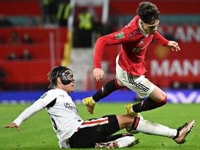 Manchester United's Argentinian midfielder Alejandro Garnacho (R) vies with Charlton's English defender Sean Clare (L) during the English League Cup quarter final football match between Manchester United and Charlton Athletic, at Old Trafford, in Manchester, north-west England on January 10, 2023.