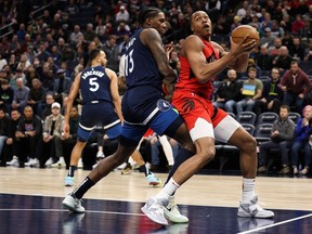 Raptors' Scottie Barnes looks to shoot while Timberwolves' Nathan Knight defends during the first quarter at Target Center on Thursday, Jan. 19, 2023.