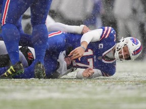 Jan 22, 2023; Orchard Park, New York, USA; Buffalo Bills quarterback Josh Allen is sacked by Cincinnati Bengals defensive end Trey Hendrickson and fumbles in the first quarter during an NFL divisional playoff football game between the Cincinnati Bengals and the Buffalo Bills during an AFC divisional round game at Highmark Stadium.