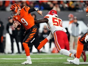 Cincinnati Bengals quarterback Joe Burrow breaks a tackle by Kansas City Chiefs linebacker Willie Gay on a run in the third quarter of a Week 13 NFL game at Paycor Stadium.