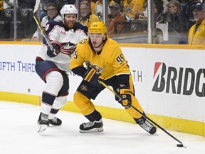 Columbus Blue Jackets defenceman Vladislav Gavrikov (left) defends against Nashville Predators centre Matt Duchene during an NHL game at Bridgestone Arena on Jan 17, 2023.