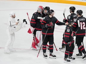 Camera operator Nathan Eides, left, records Canada celebrating a win over Sweden during IIHF World Junior Hockey Championship action in Halifax on Saturday, December 31, 2022.