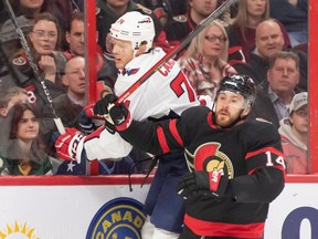 Senators winger Tyler Motte checks Capitals defenceman John Carlson during a Dec. 22 game in Ottawa. Motte injured a finger later in that contest, which kept him sidelined until he made his return to the lineup on Saturday against the Canadiens.
