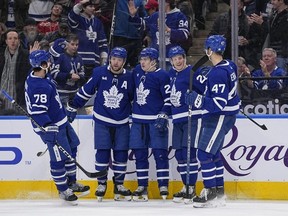 Toronto Maple Leafs defenseman TJ Brodie, defenseman Morgan Rielly, forward Dryden Hunt and forward Pierre Engvall celebrate a goal by forward Pontus Holmberg against the Detroit Red Wings during the third period at Scotiabank Arena.