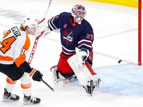 Philadelphia Flyers right wing Owen Tippett (74) scores past Winnipeg Jets goaltender Connor Hellebuyck (37) in the third period at Canada Life Centre in Winnipeg on Saturday, Jan. 28, 2023.