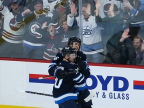 Winnipeg Jets forward Morgan Barron (36) is congratulated by Winnipeg Jets forward Karson Kuhlman (20) on his goal against the Tampa Bay Lightning during the third period at Canada Life Centre in Winnipeg on Friday, Jan. 6, 2023.