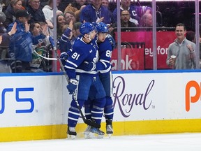 Maple Leafs' William Nylander (right) celebrates with teammate John Tavares after scoring a goal against the New York Islanders during the second period at Scotiabank Arena on Monday, Jan. 23, 2023.