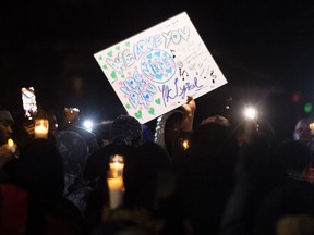 People attend a vigil in memory of Nicous D'Andre Spring in Montreal, Friday, Dec. 30, 2022.