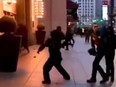 Screen shot of rioters throwing bricks at building in Atlanta.