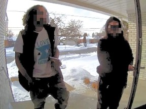 Two intruders captured on a doorbell camera entered a home and stole a laptop after a 13-year-old boy answered the door.