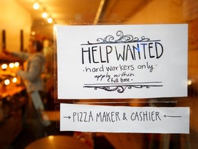 A Help Wanted sign is seen in the window of a bakery in Ottawa.