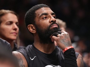 Kyrie Irving of the Brooklyn Nets looks on from the bench during the third quarter of the game against the Indiana Pacers at Barclays Center on Oct. 31, 2022 in New York City.