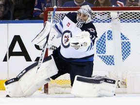 Connor Hellebuyck of the Winnipeg Jets makes the third period save against the New York Rangers at Madison Square Garden on Feb. 20, 2023 in New York City. The Jets defeated the Rangers 4-1.