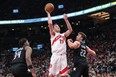 Toronto Raptors' Jacob Poeltl scores on Orlando Magic's Wendell Carter Jr. (left) and Franz Wagner.