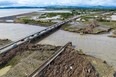 An aerial photo shows a rail bridge (R) damaged and washed away during Cyclone Gabrielle near Napier on February 16, 2023. (Photo by STR/AFP via Getty Images)