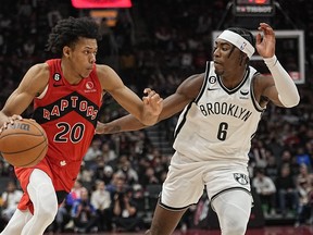 Raptors guard Jeff Dowtin Jr. drives to the net against Brooklyn Nets forward David Duke Jr., during their game in November at Scotiabank Arena.