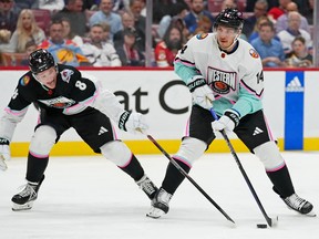 Central Division defenceman Cale Makar (8) of the Colorado Avalanche reaches for the puck against Pacific Division forward Bo Horvat (14) of the New York Islanders during the 2023 NHL All-Star Game at FLA Live Arena.