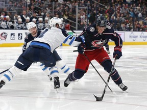 Feb 16, 2023; Columbus, Ohio, USA; Winnipeg Jets defenseman Neal Pionk (4) checks Columbus Blue Jackets right wing Patrik Laine (29) during the second period at Nationwide Arena. Mandatory Credit: Russell LaBounty-USA TODAY Sports