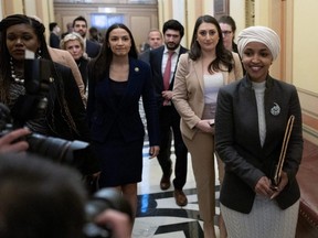 U.S. Rep. Ilhan Omar (D-MN), right, walks to her office after being ousted by the Republican-lead House of Representatives to serve on the Foreign Affairs Committee, on Capitol Hill in Washington, D.C., Thursday, Feb. 2, 2023.