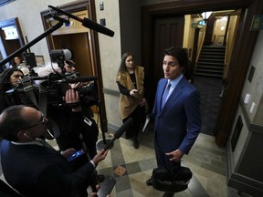 Prime Minister Justin Trudeau talks to reporters in the foyer as he arrives for question period in the House of Commons on Parliament Hill in Ottawa, Monday, Feb. 6, 2023.