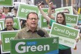 Guelph MPP Mike Schreiner, leader of the Green Party of Ontario, speaks during campaign stop at Oxford and Wharncliffe, while London North Centre candidate Carol Dyck waves to supporters on Oxford Street on June 1, 2022.
