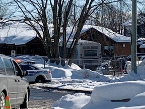 Police in Laval, Que., secure the scene where a city bus crashed into a day care centre, Wednesday, Feb. 8, 2023.