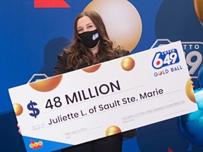 Juliette Lamour, 18, of Sault Ste Marie, Ont. with her cheque for $48 million.