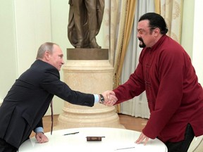 Russia's President Vladimir Putin (left) shakes hands with U.S. actor Steven Seagal during a meeting at the Kremlin in Moscow, Nov. 25, 2016.