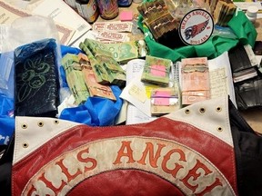 Items seized during a 13-month police investigation dubbed Project Coyote -- including drugs, guns, ammo, cash and outlaw motorcycle gangs colours of Hells Angels and Red Devils MC puppet gang members -- are displayed in images released by the OPP on Wednesday, Feb. 22, 2023.