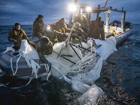 Sailors assigned to Explosive Ordnance Disposal Group 2 recover a high-altitude surveillance balloon off the coast of Myrtle Beach, S.C., Sunday, Feb. 5, 2023.