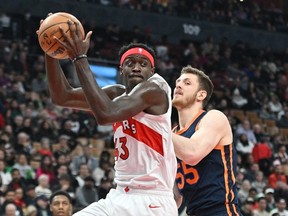 Toronto Raptors forward Pascal Siakam takes in a rebound beside New York Knicks center Isaiah Hartenstein in the first half at Scotiabank Arena.