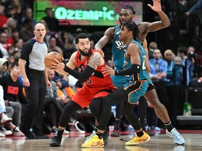 Raptors' Fred VanVleet looks to pass the ball as he is covered by Detroit Pistons' Jaden Ivey and Isaiah Stewart during the second half at Scotiabank Arena on Sunday, Feb. 12, 2023.